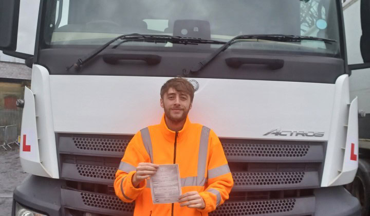 A photo of Zak with his certificate after his 3A first time pass.