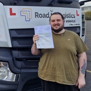 Image of Aaron displaying his pass certificate.